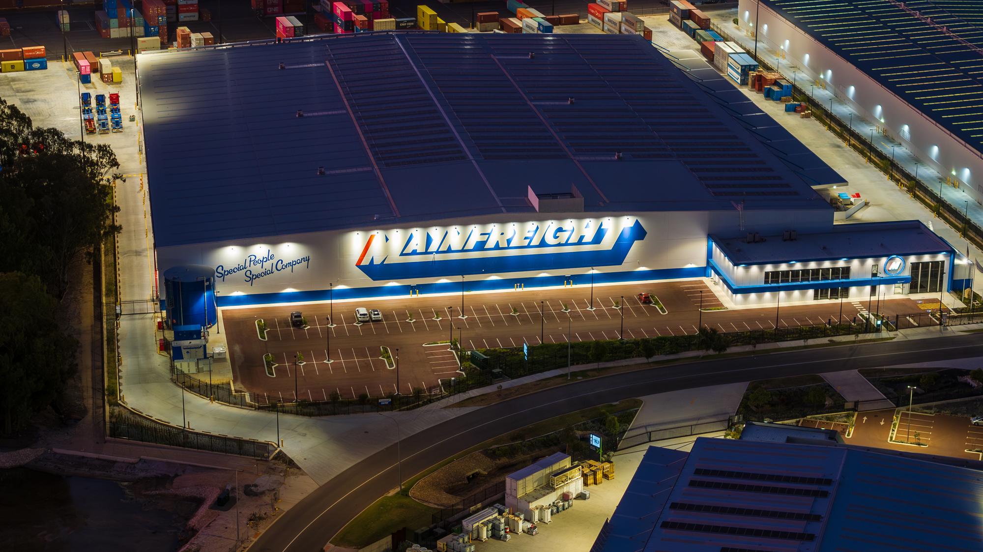 Aerial view at dusk of a large distribution centre with perimeter security fencing